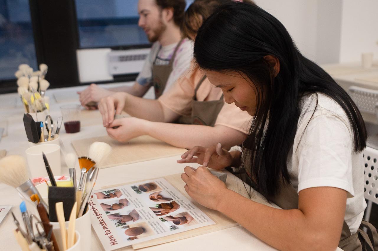 Students learning hand building in a Gotham Pottery course