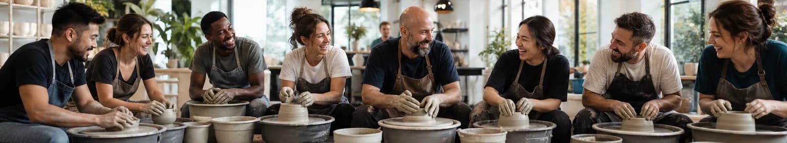 A group enjoying a private pottery team building event in a studio